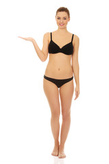 Fototapeta premium Woman in bikini with empty hand.