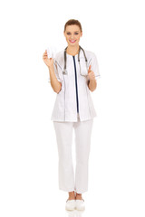 Fototapeta premium Female dentist holding a tooth model.