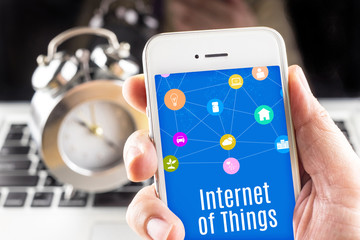 Close up Two hand holding smartphone with Internet of things wor