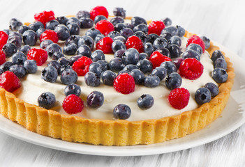Cake with  blueberries on a white plate.