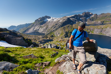 Man takes rest on top of mountain in Norway