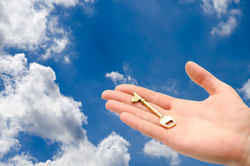 hand with a key in the sky