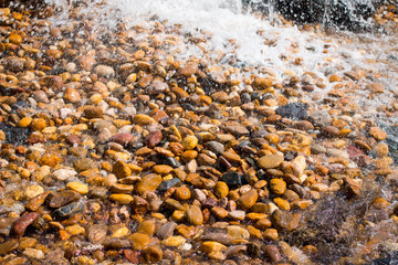The movement of water on the rocks.