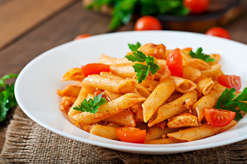 Penne pasta in tomato sauce with chicken, tomatoes