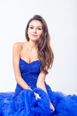 Young woman in a beautiful blue evening dress