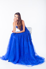 Young woman in a beautiful blue evening dress