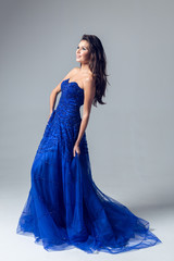 Young woman in a beautiful blue evening dress