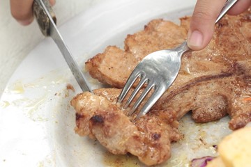 steaks and vegetable salad with french fries.