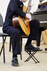 boy plays the guitar during a concert