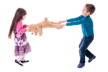 Boy and girl pulling toy bear