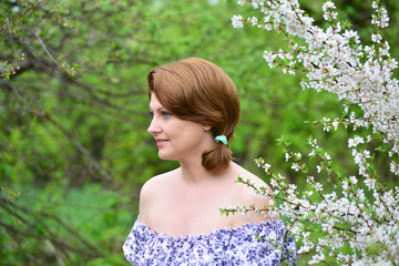 adult woman near the cherry blossoms