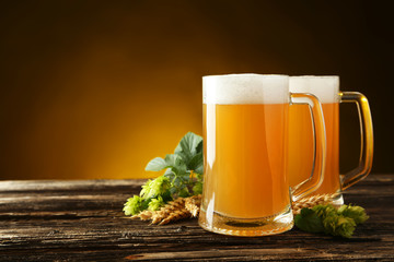 Mug of beer on a brown wooden background
