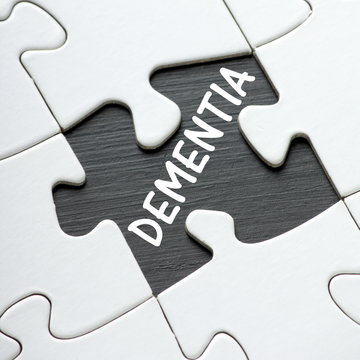 The word DEMENTIA under a missing jigsaw puzzle piece