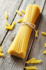 Spaghetti on grey wooden background