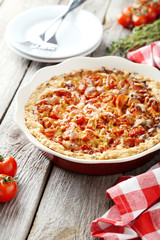 Fresh tomato pie on grey wooden background