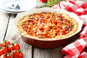 Fresh tomato pie on grey wooden background