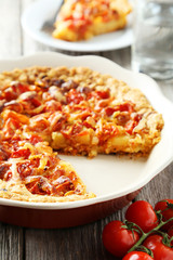 Fresh tomato pie on grey wooden background