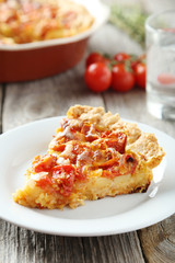 Fresh tomato pie on grey wooden background