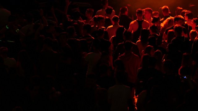 Crowd of young people dancing on party