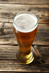 Glass of beer on brown wooden background