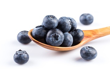 Fresh blueberries in wooden spoon