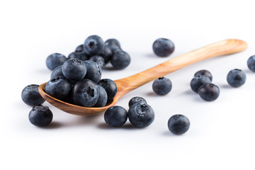 Fresh blueberries in wooden spoon