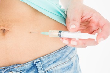 Woman injecting fluid in her stomach