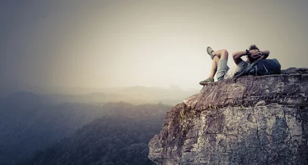 Deurstickers Hiker relaxing on the rock © Dudarev Mikhail