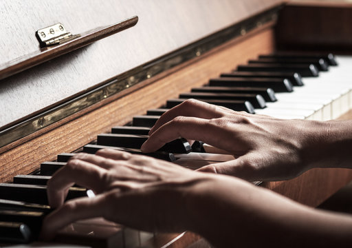 Close up of female hands playing piano