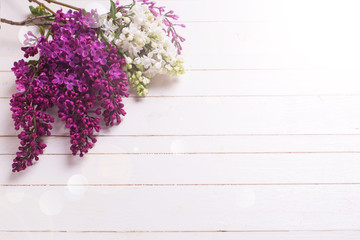 Lilac flowers on wooden background.