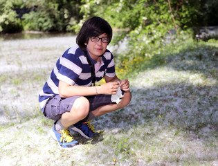 young boy with pollen allergy with white handkerchief