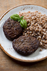 Close-up of fried beef cutlets with buckwheat, studio shot