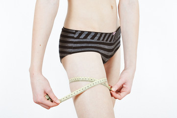 Girl measuring her thigs