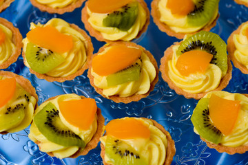 Delicious mini tart with kiwi and oranges slices