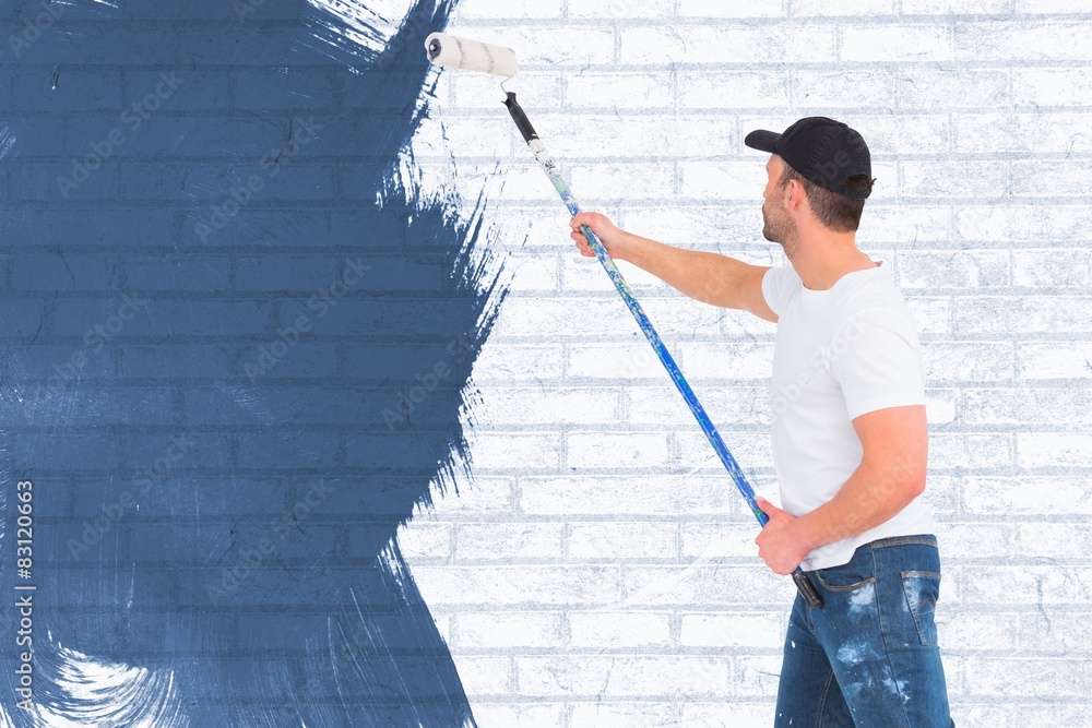 Poster composite image of handyman painting with roller