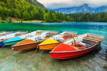 Fototapeten Stunning alpine landscape and colorful boats,Lake Fusine,Italy © janoka82