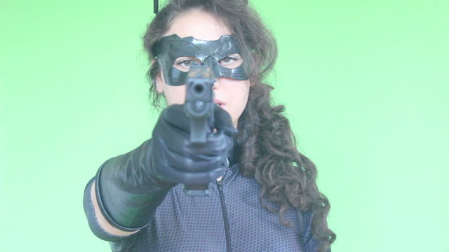 young girl shooting with gun green screen