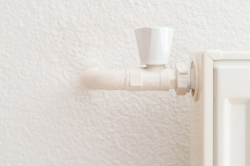 White heating radiator in an apartment. Detail shot 