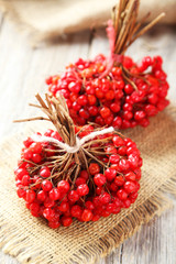 Bunch of viburnum on sackcloth, on grey wooden background