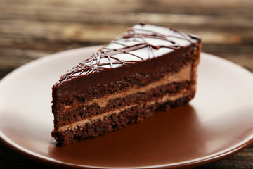 Dark chocolate cake on brown wooden background