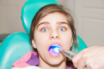 Girl is being treated by a dentist