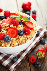 Oatmeal with berries on brown wooden background