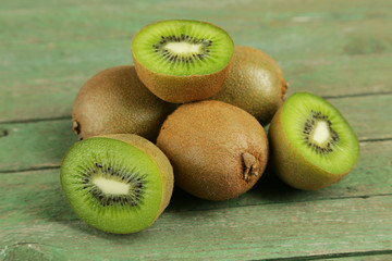 Kiwi fruit on green wooden background