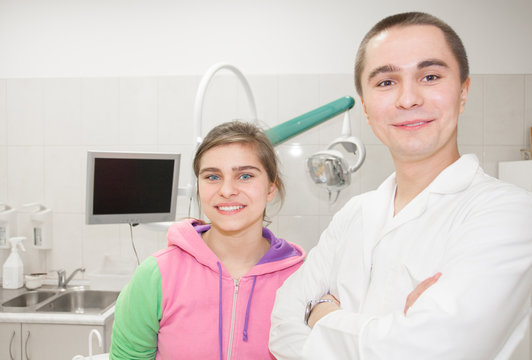 Young dentist standing with a young patient