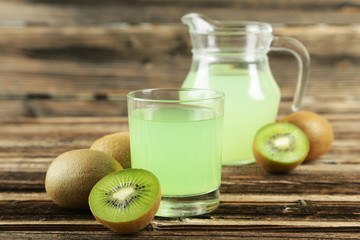 Fresh juice with kiwi on brown wooden background