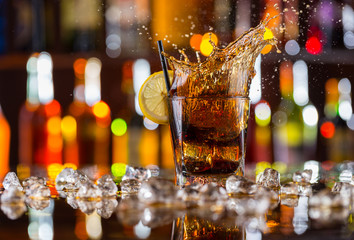 Glass of cola drink on bar counter