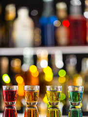 Variation of hard alcoholic shots on bar counter