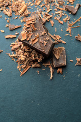 Dark chocolate stack, chips and powder. Shallow depth of field.