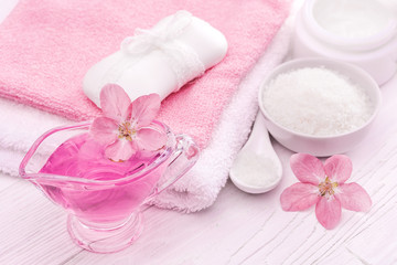Fototapeta na wymiar sea salt and essential oils, pink flower. spa