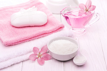 Obraz na płótnie Canvas sea salt and essential oils, pink flower. spa
